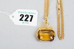 A nine carat gold flat curb necklace, approximately 15 grms with an amber stone pendant on a yellow