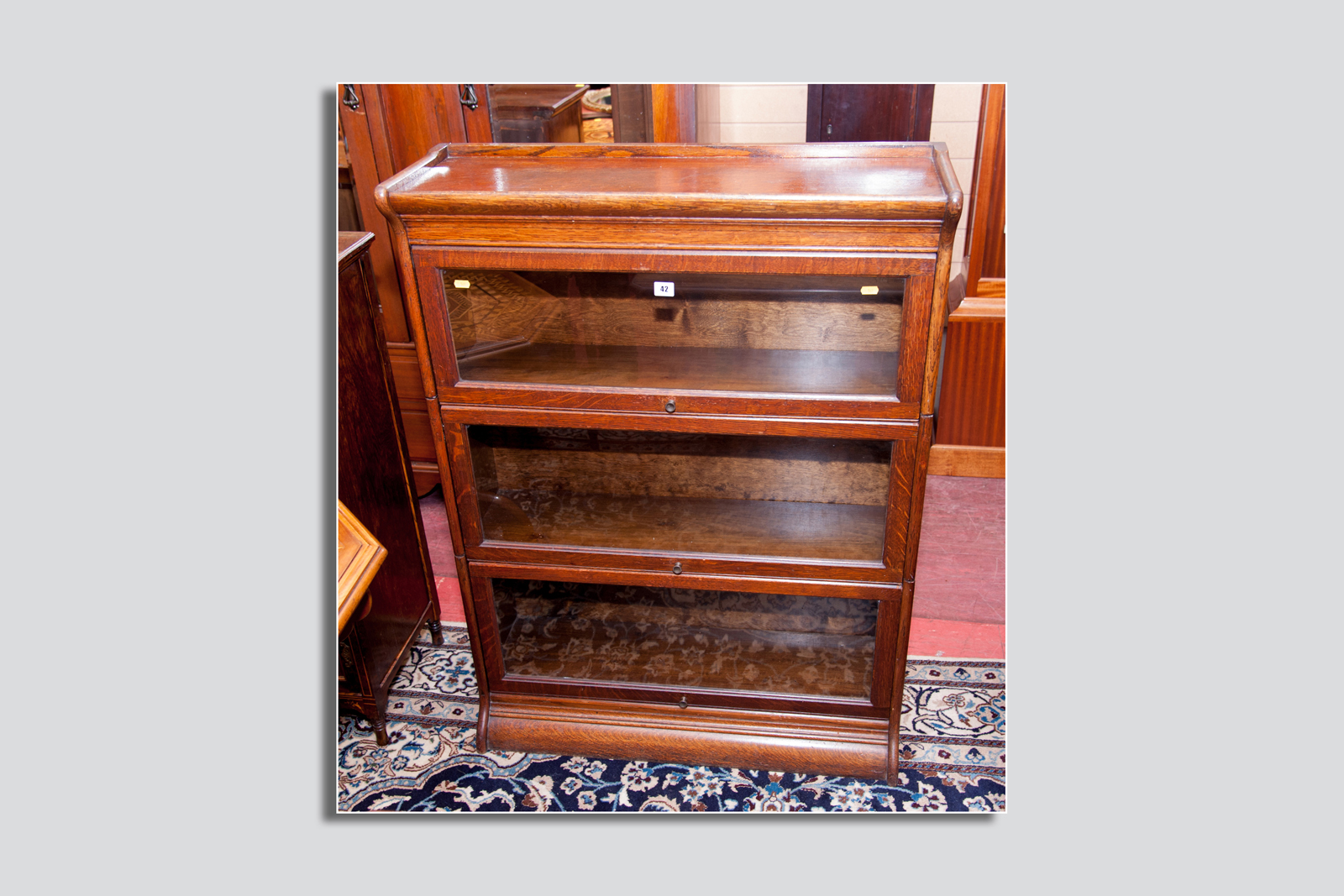 A three section Globe Wernicke style oak stacking bookcase, 46.5 x 34.5 ins (118 x 87 cms)