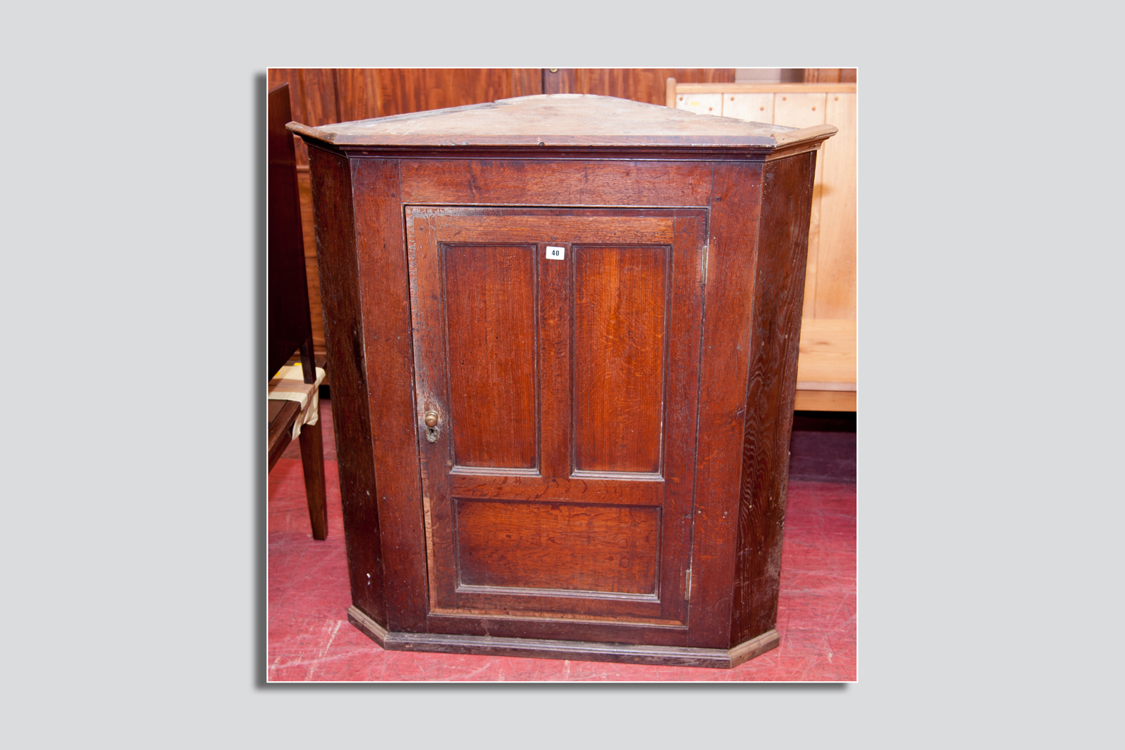 A Victorian oak wall hanging corner cupboard, a single centre door below a moulded cornice, the