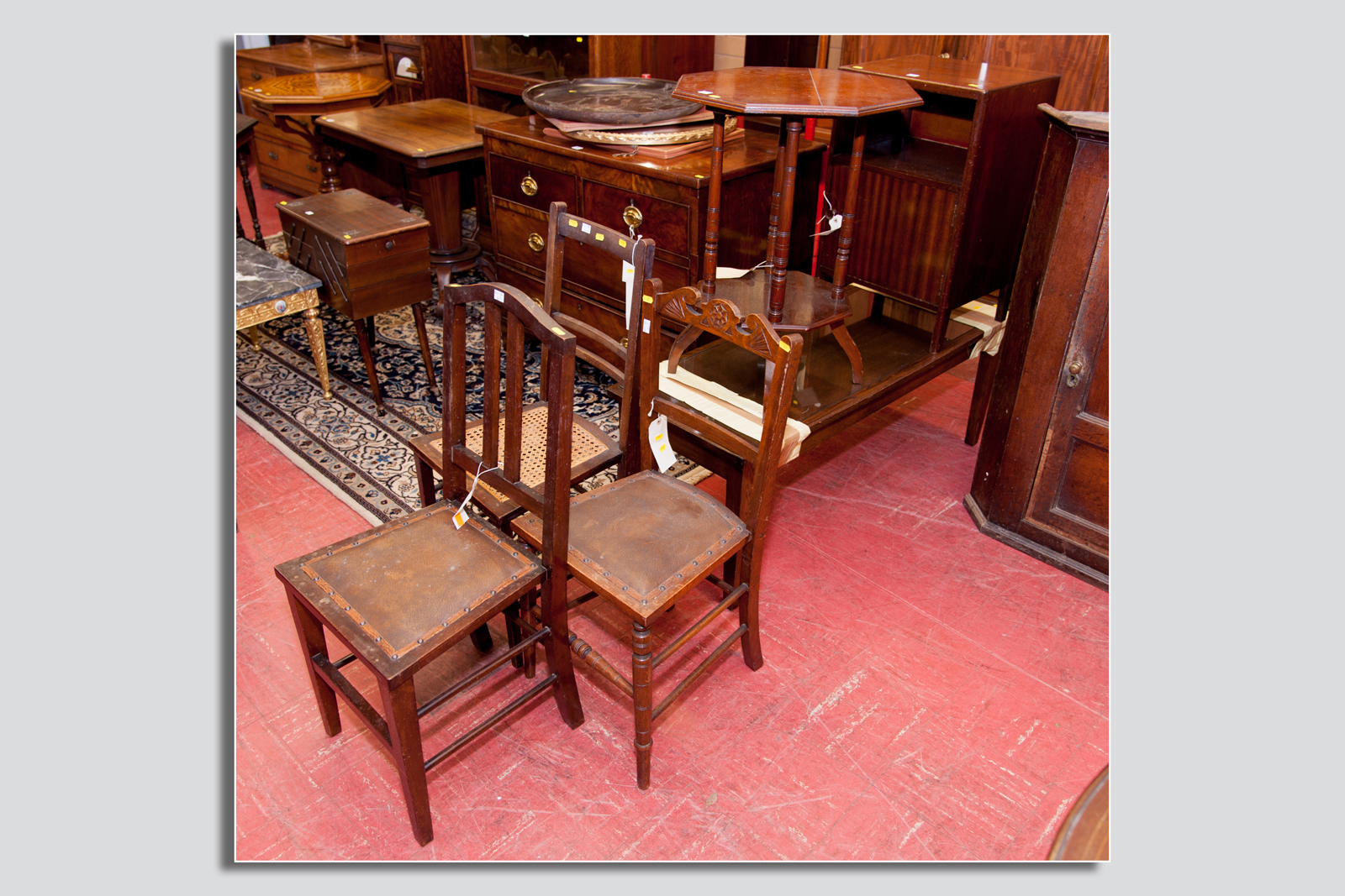 An Edwardian mahogany octagonal topped occasional table with base shelf, three occasional chairs, a