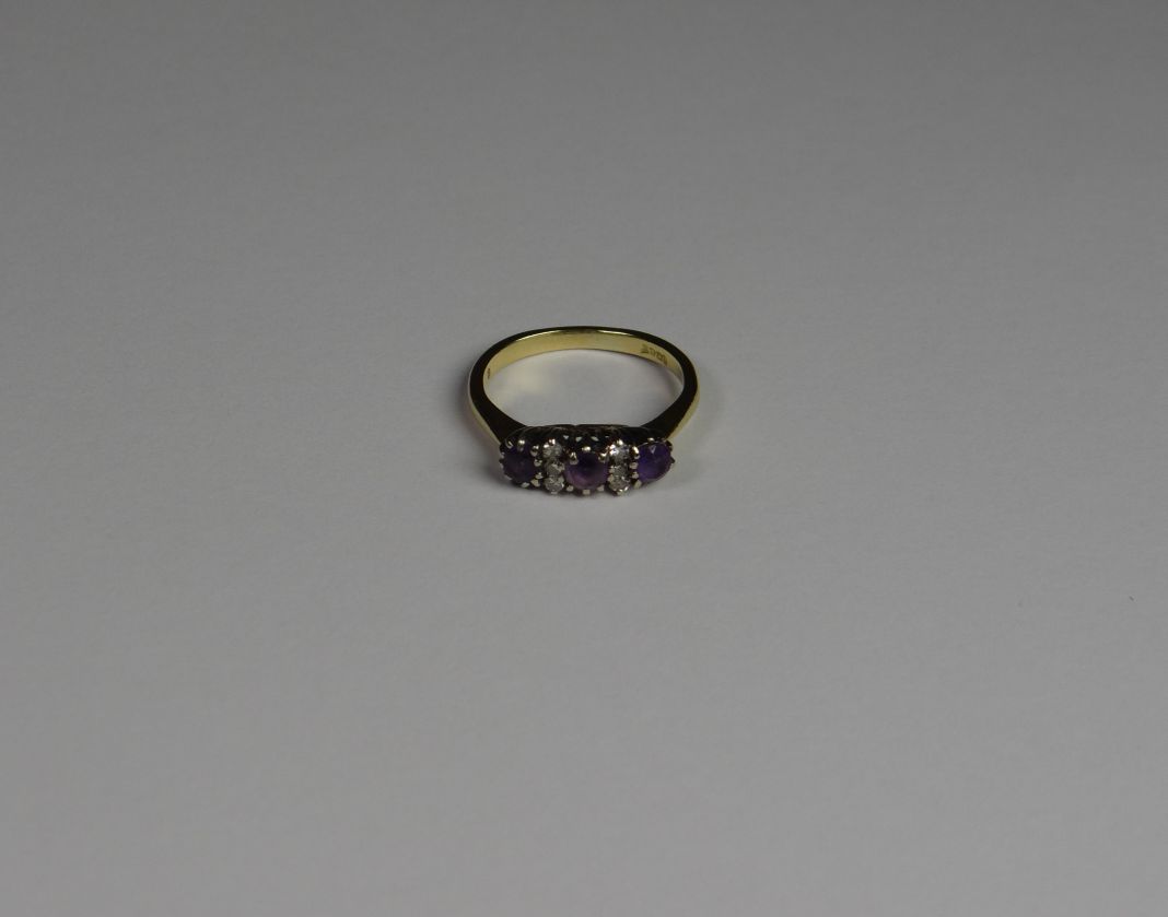 An 18ct yellow gold amethyst and diamond 9 stone ring