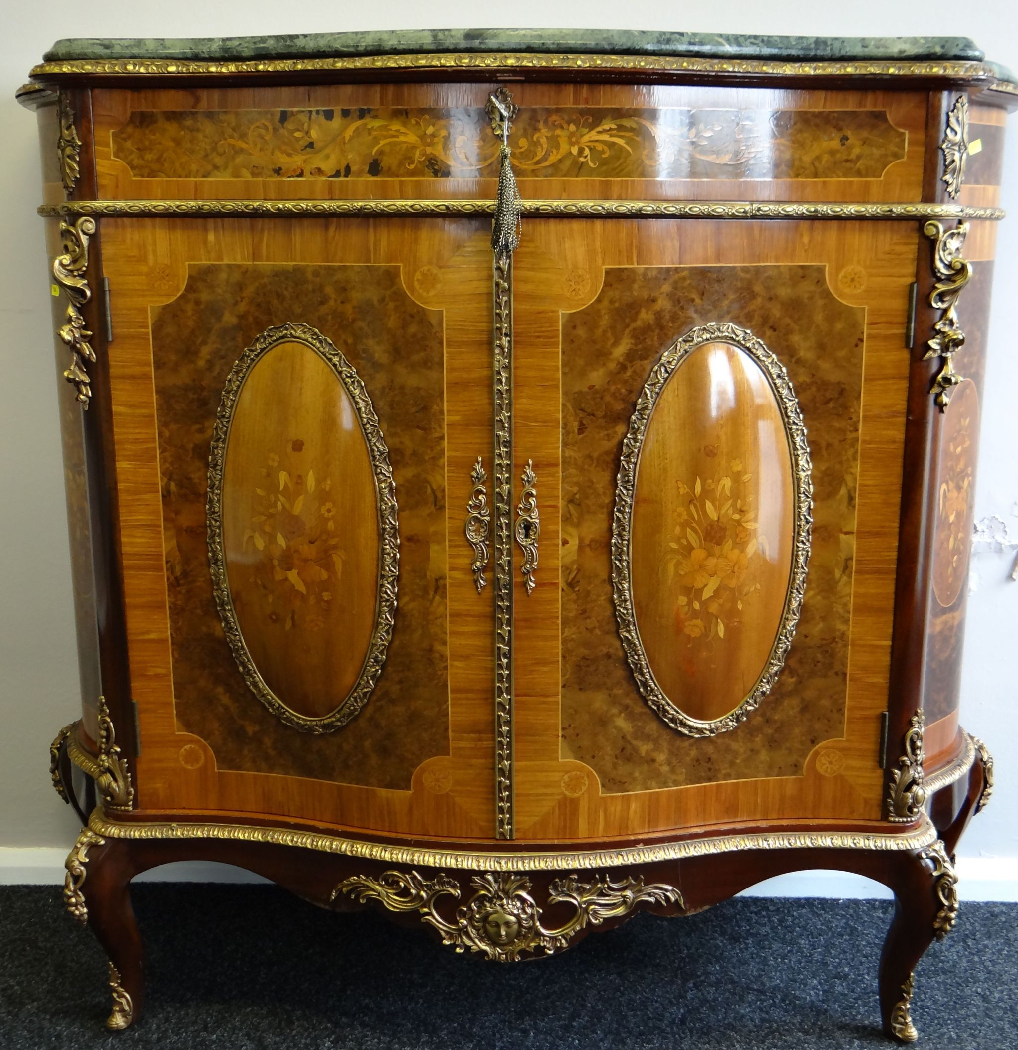 A late Louis XV style serpentine wine commode by H & L Epstein (London & Manchester), the frieze