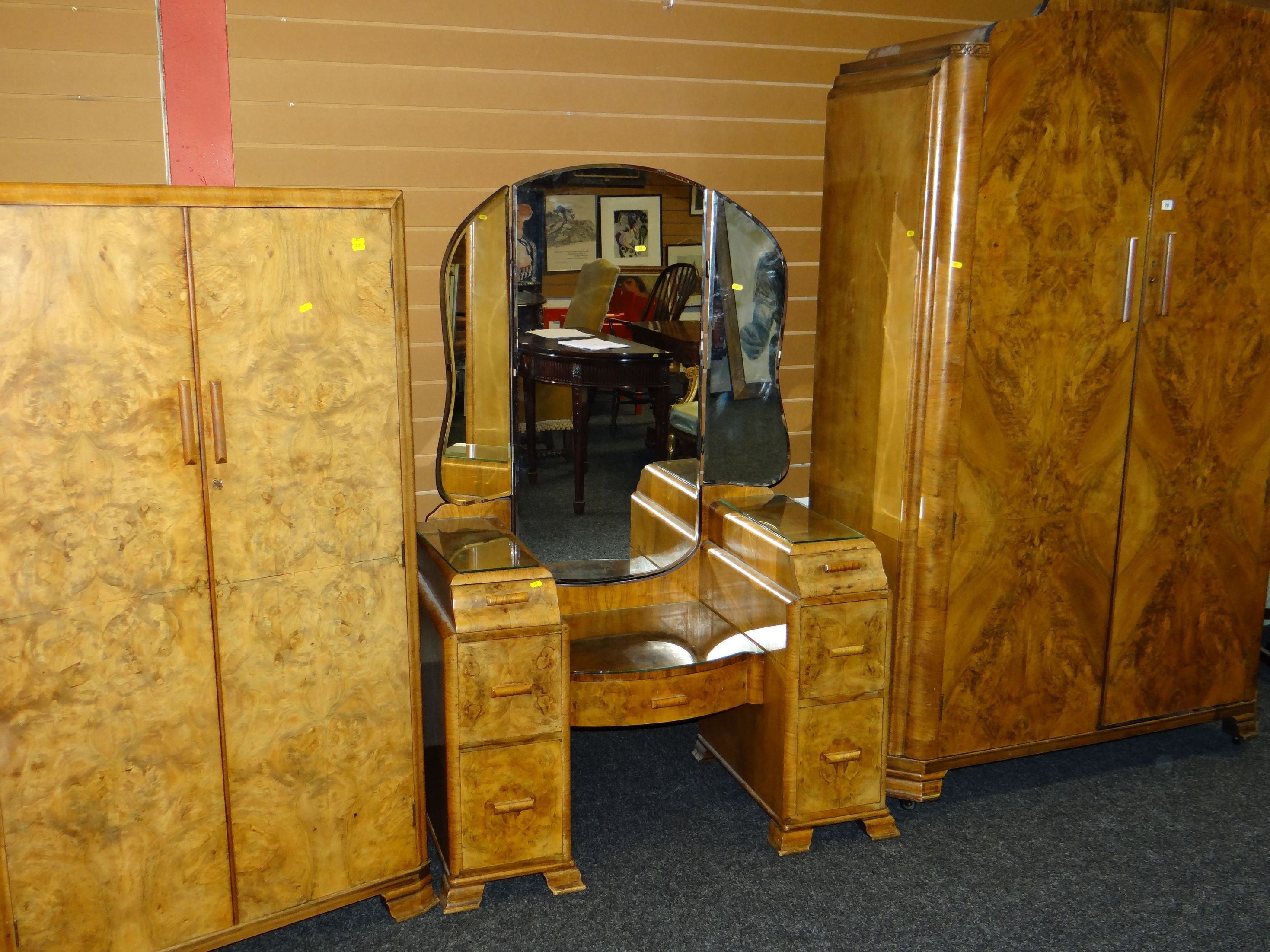 An art deco period polished bedroom suite comprising wardrobe, bed-ends, dressing table and tallboy