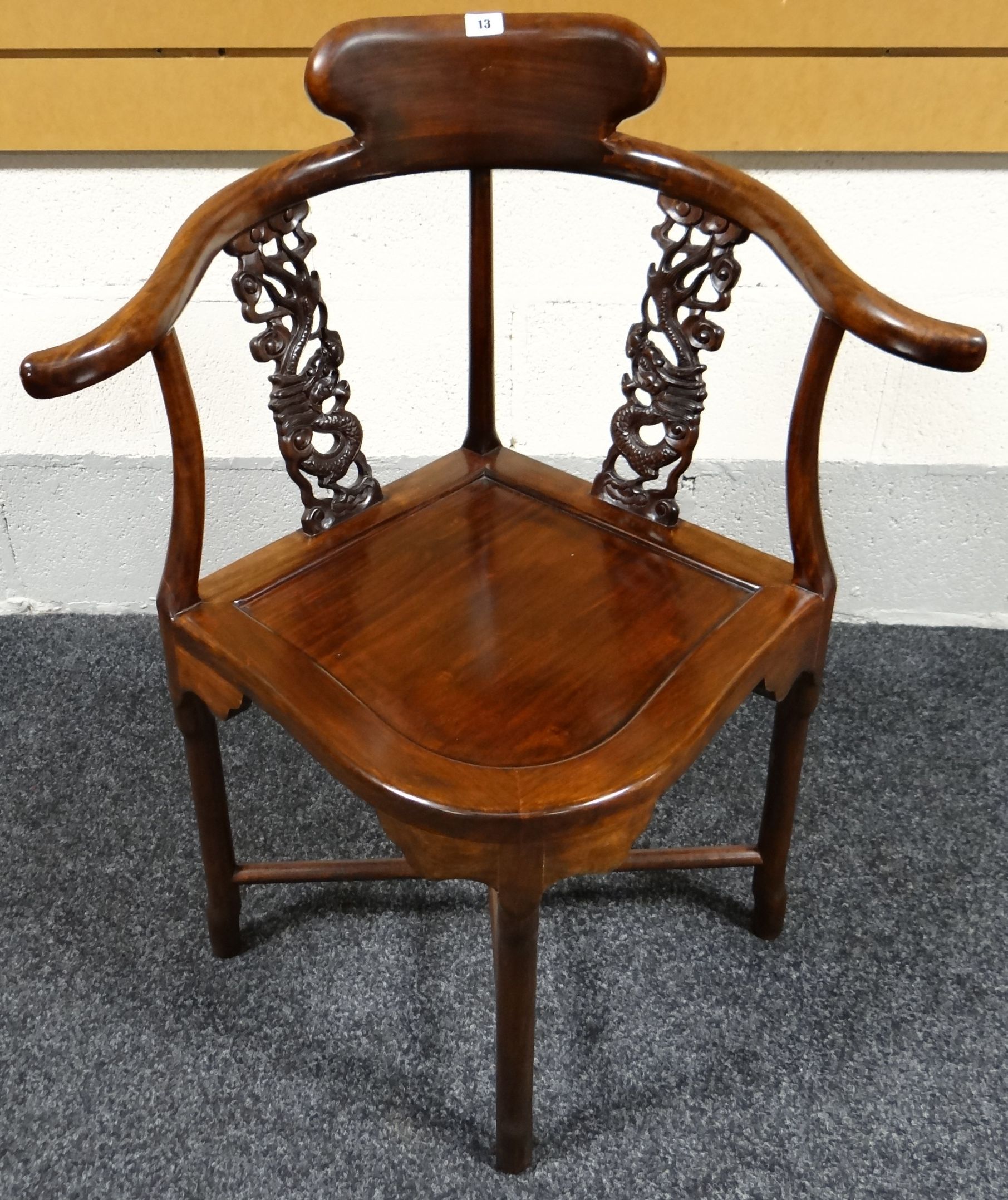A Chinese rosewood corner-chair having a pair of carved dragon in cloud splats