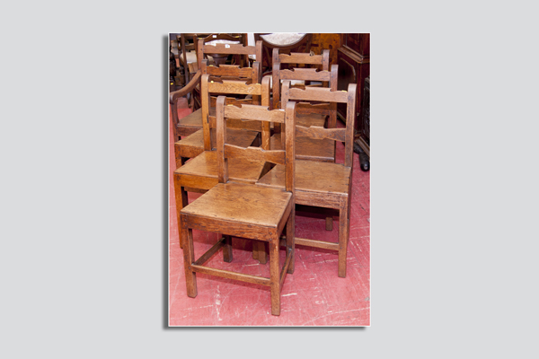 A set of six antique oak farmhouse chairs, each having a shaped centre and top rail and with