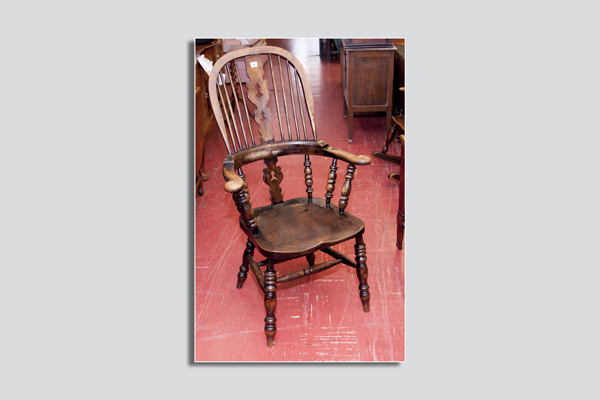 A 19th Century elm splat and spindlebacked armchair having curved arms with bobbin supports and