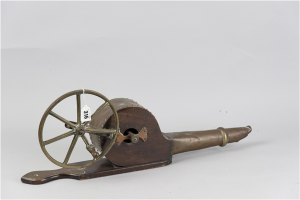 A 19th Century brass and mahogany wall hung wheel fire bellows, 24 ins (61 cms) long