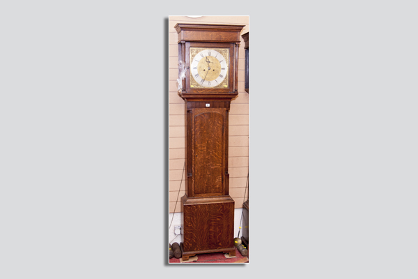 An early 19th Century compact oak longcase clock having a square hood with Corinthian pillars and