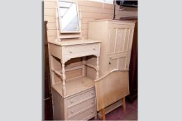 A three piece maple bedroom suite of single wardrobe with carved door, dressing table with swing