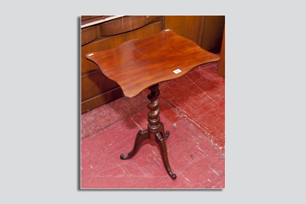 A small Victorian mahogany tripod table having a shaped top to a twist centre pedestal and three