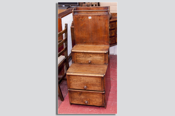 A sailor`s polished cabin compactum of narrow form having a brass rail to a top shelf, a centre