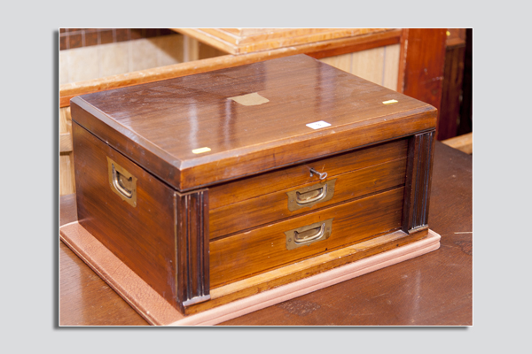 A mahogany two drawer cutlery canteen with rising top lid and end brass carrying handles