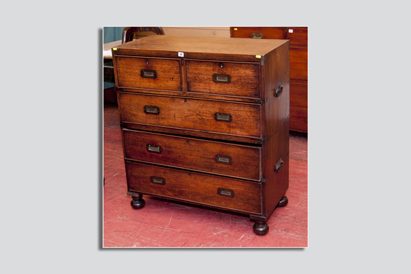 A late 19th Century mahogany two piece campaign chest, the upper section having one long drawer and