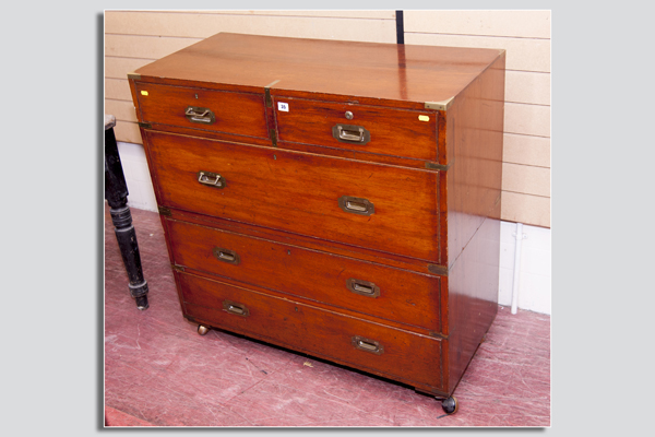 A 19th Century mahogany one piece campaign style chest, brass corner banded and having three long