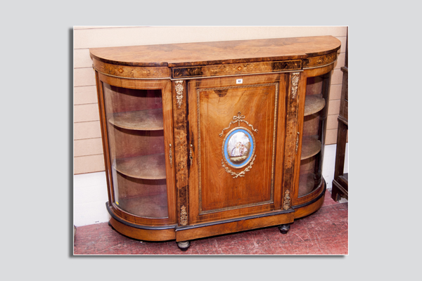 A Victorian walnut and ormolu breakfront credenza, the breakfront having a single door with fine