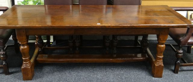 A polished oak reproduction refectory table on turned and block supports, 31 x 89ins (79 x 226cms)