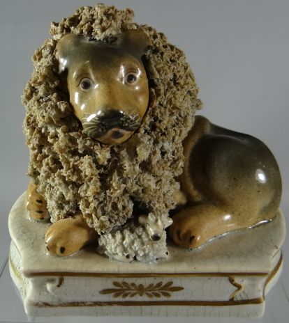 A Staffordshire lion and lamb group by Lloyd of Shelton, the lion recumbent with lamb in the front,