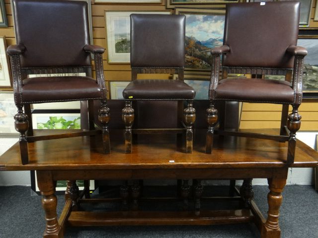 A set of six dining chairs (4 + 2 carvers) in studded leatherette covers and having pineapple