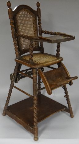 An early 20th Century oak metamorphic baby high-chair by Millsons, London, cane-seated and having a
