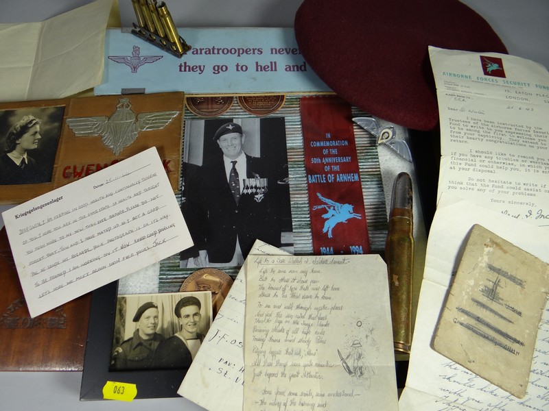 A parcel of assorted WWII paratrooper ephemera relating to a Prisoner of War, to include a beret,