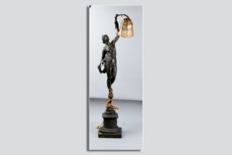 A tall figural table lamp of a young scantily clad maiden holding a lamp aloft standing upon a