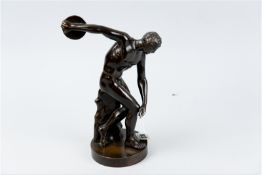 A circular based hollow bronze figurine of an Olympian, 10.25 ins (26 cms) high, un-named/