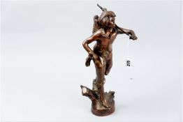 A bronze figurine of a standing country figure, the left hand bearing a stick holding a basket of
