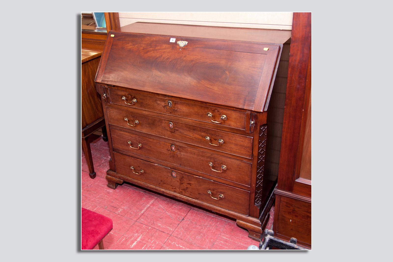 A Georgian mahogany bureau, the slope front revealing an interior of centre cupboard with four