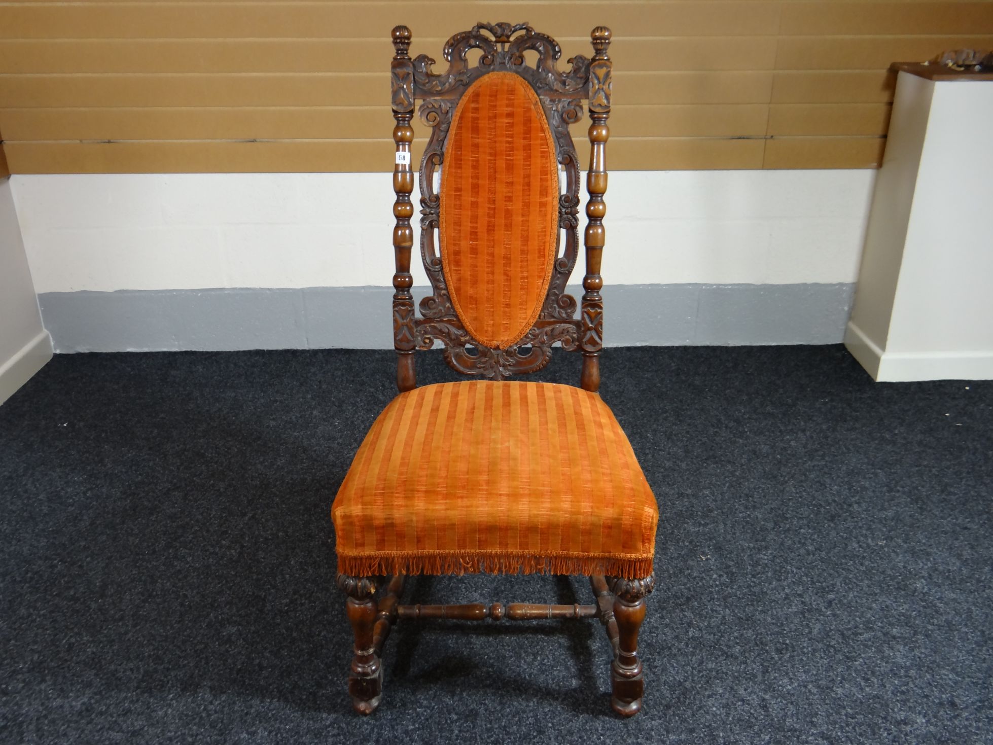 A Victorian carved hall chair with upholstered cushion seat and oval cushion back on turned and