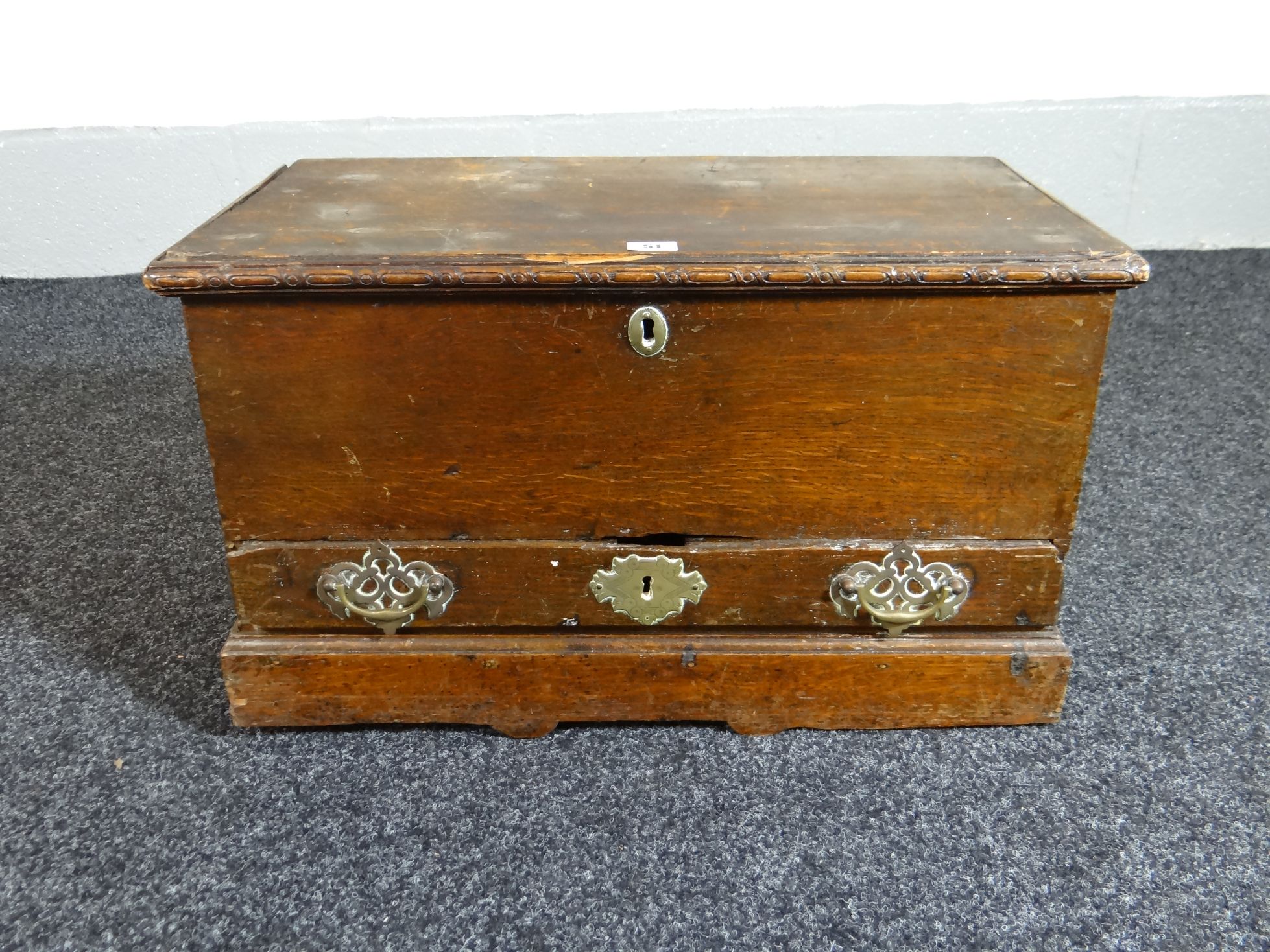 A late eighteenth century oak Welsh coffer-bach, with single base drawer and with original brass