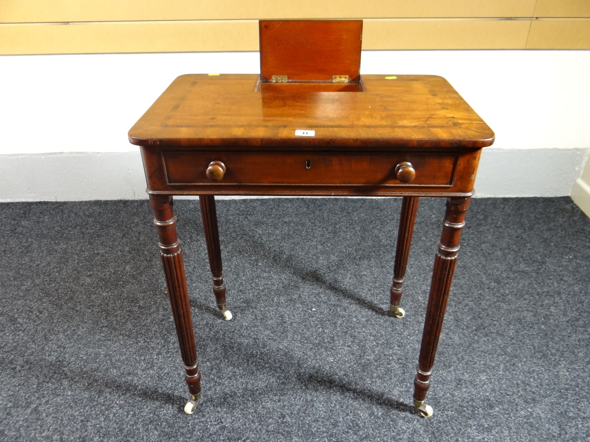 A late Victorian mahogany cross-banded postal desk, having a small hinged lid compartment insert,