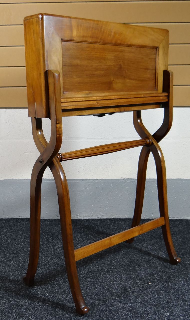 An Edward VII folding mahogany campaign writing-desk on elegant cross-supports and with fluted