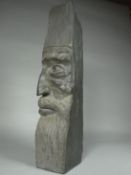 A curious slate carved half-bust of a bearded man, 16ins high (41cms)