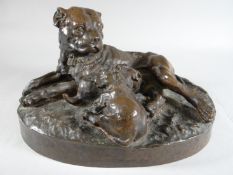A patinated bronze bull mastiff and two pups on an oval naturalistic base, cast after W Wolfe,
