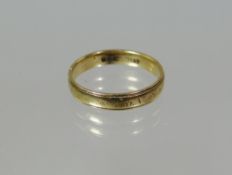 A 9ct yellow gold band ring, 2gms