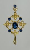 An Edwardian seed pearl and blue stone set floral pendant, 4.3cms long