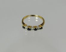 A 9ct sapphire and tiny diamond half hoop eternity ring