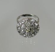 An 18ct white gold nineteen stone diamond cluster ring set with old brilliant cut diamonds and