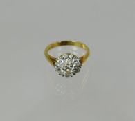 An 18ct yellow gold diamond floral cluster ring with raised centre diamond crown surrounded by six