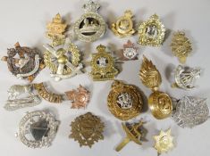 Twenty assorted regimental cap badges