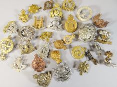 Thirty assorted regimental cap badges