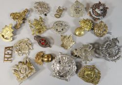 Twenty assorted regimental cap badges