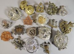 Twenty assorted regimental cap badges