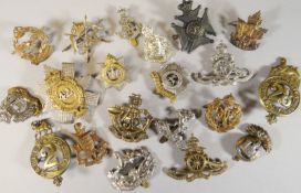 Twenty assorted regimental cap badges