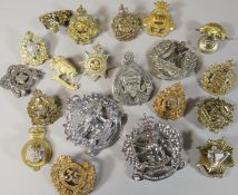 Twenty assorted regimental cap badges