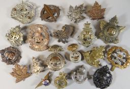 Twenty assorted regimental cap badges