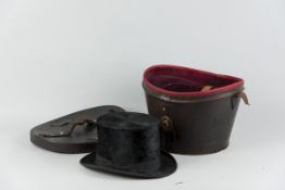 A silk top hat, size approximately 8 x 6.5 ins (27 x 16 cms) in a good leather case with lock