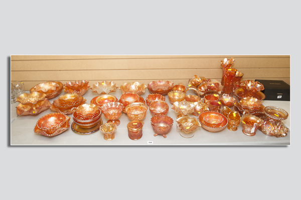 Approximately seventy-five pieces of carnival glass marigold ware - punch bowl and cups, vases,