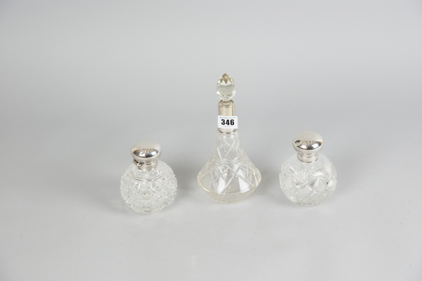 Two globular cut-glass cologne bottles with silver tops, each identically marked for Birmingham 1971