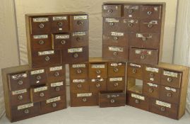 A set of five pine apothecary wall-cabinets each with banks of eight deep drawers in three rows